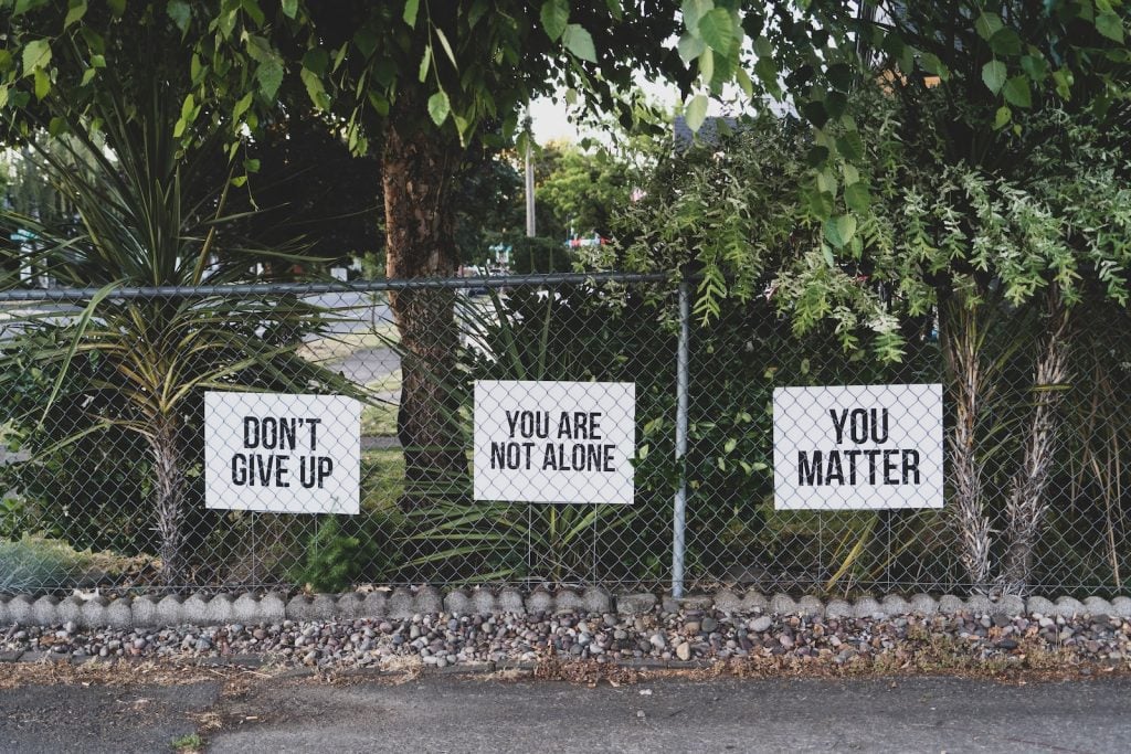 don't give up. You are not alone, you matter signage on metal fence