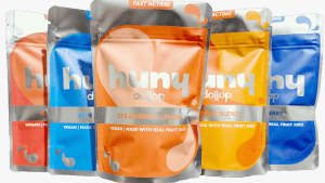 Image showing packaging of various troche flavors from the huny product line