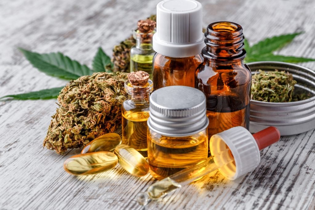 Leaves of cannabis with extract oil. Medical marijuana flower buds. CBD. THC.